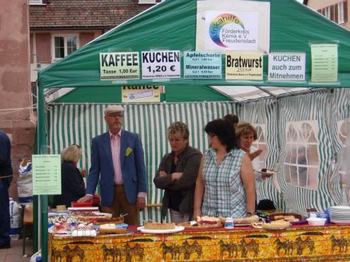 Society members selling coffee, cake, German sausages, and non-alcoholic drinks.
